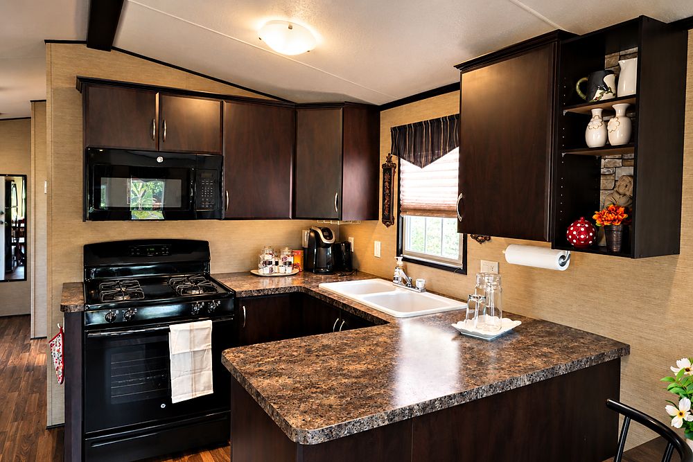 The Peacedale Cottage kitchen with a full-size gas range, microwave, double sink and coffee maker